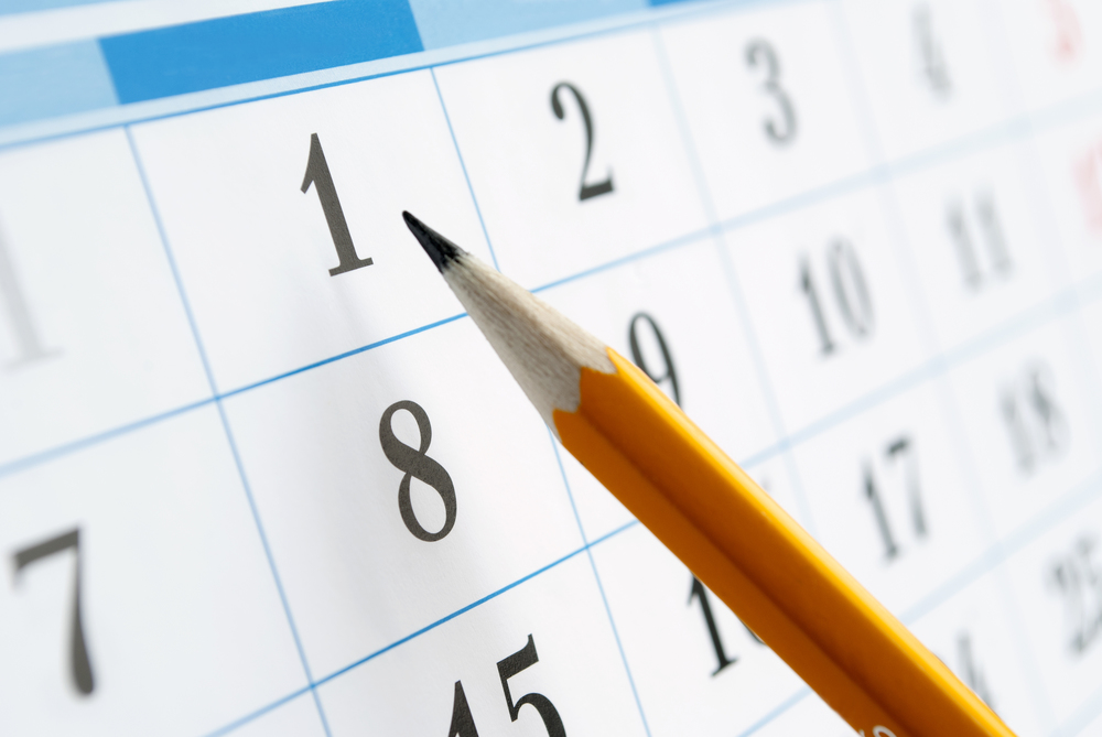 home calendar with dates and yellow sharpened pencil