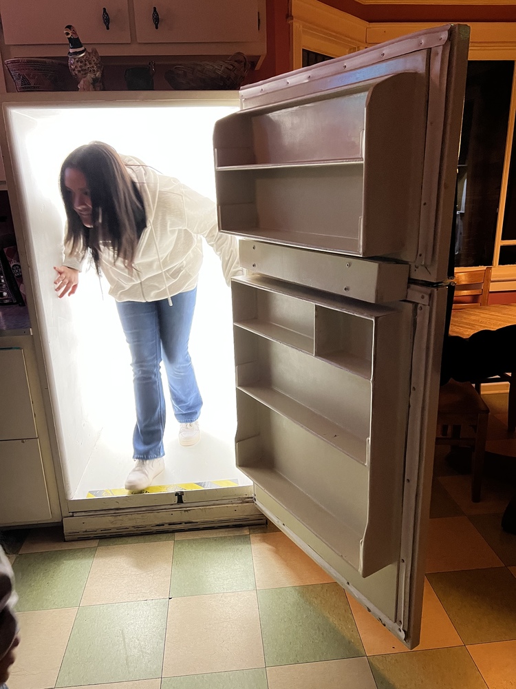 A Milagro 8th grade student follows the path within the refrigerator.