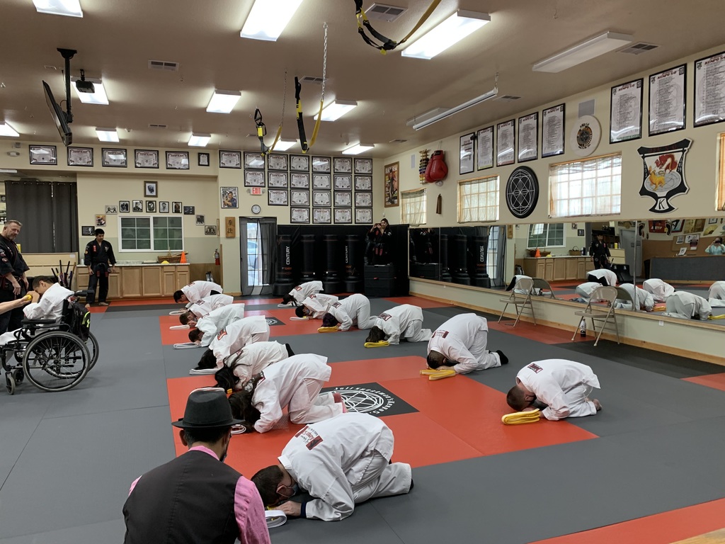 Students bowing on their yellow belts