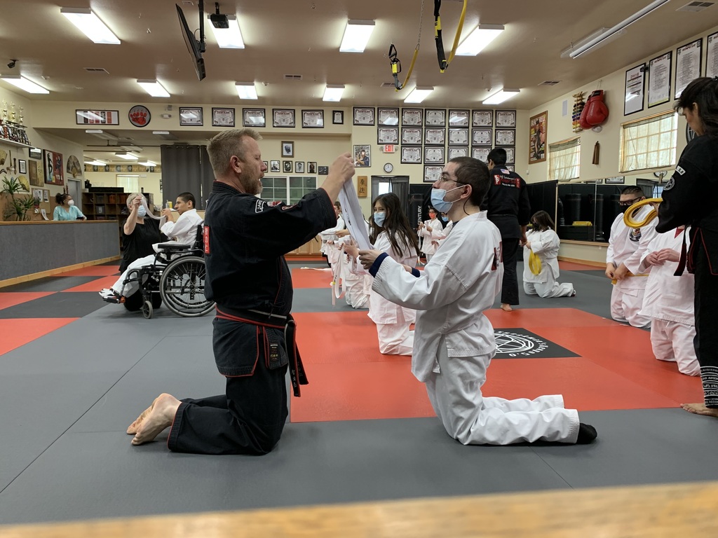 Mr. Tony Potter, Chris Cazares removing his white belt to receive his yellow belt