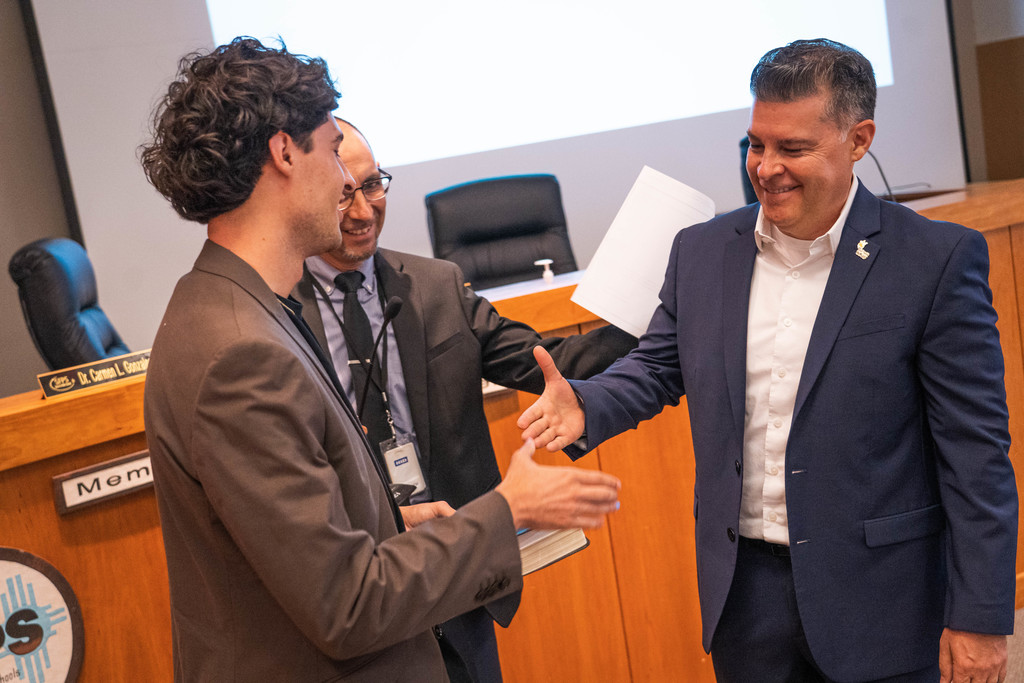 Board Member Abeyta shaking the hand of his son Dillon