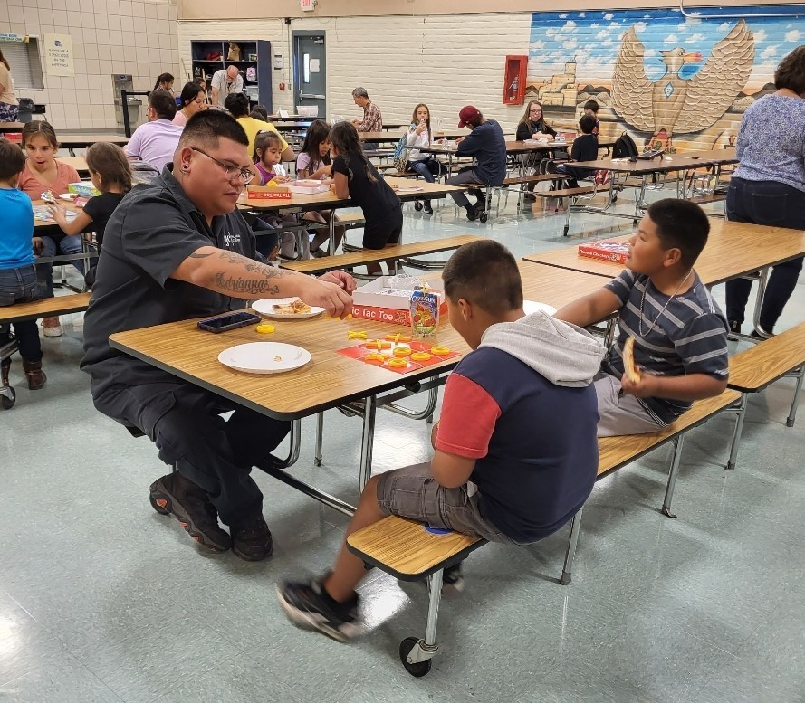 Parents and kids enjoying board games at school