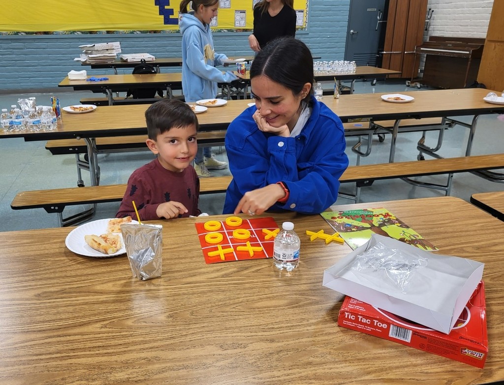 Parents and kids enjoying board games at school
