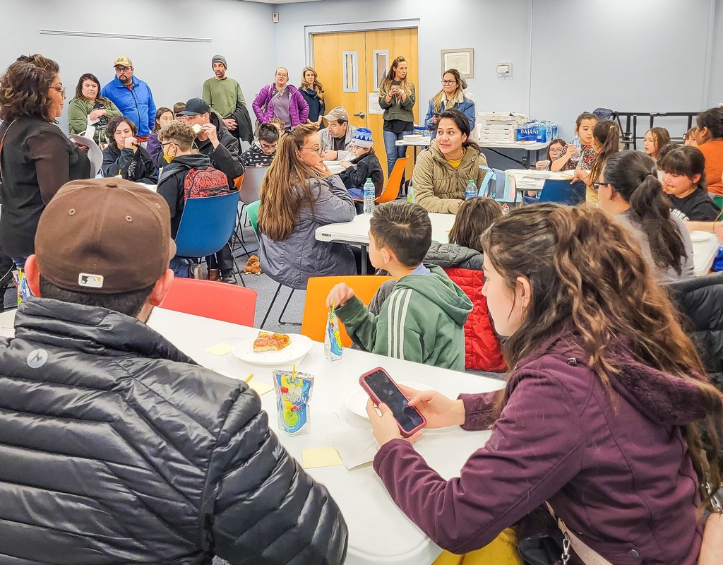 Parents and students eating and learning about the library