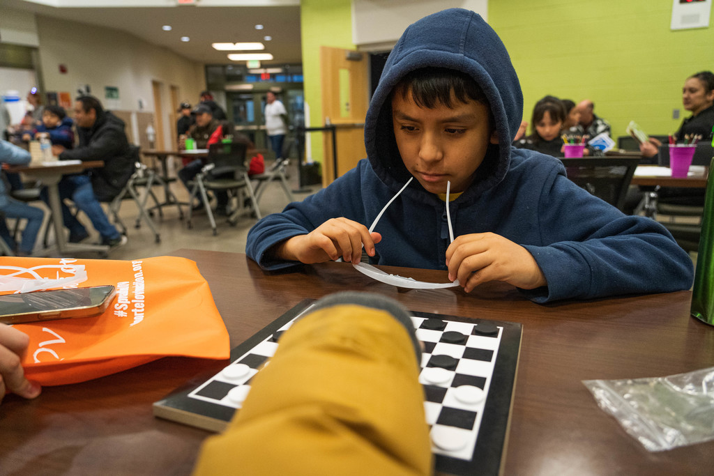 Male student observing a checkers game