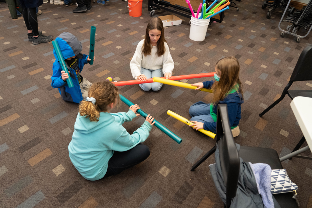 Students creating beats with music sticks