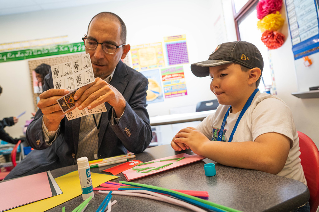 Superintendent Chavez assisting male student