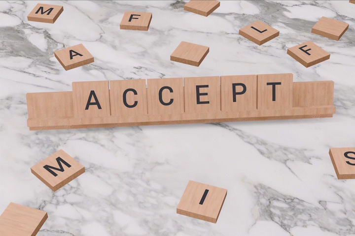 Accept on scrabble on marble table