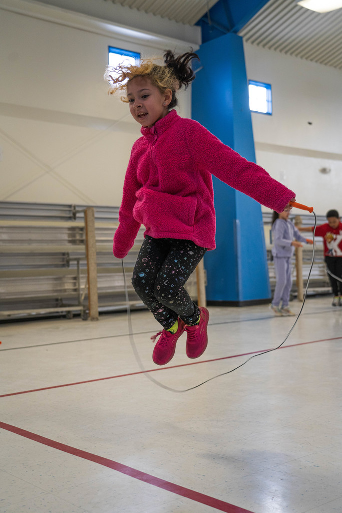Female student jumping solo with jump rope