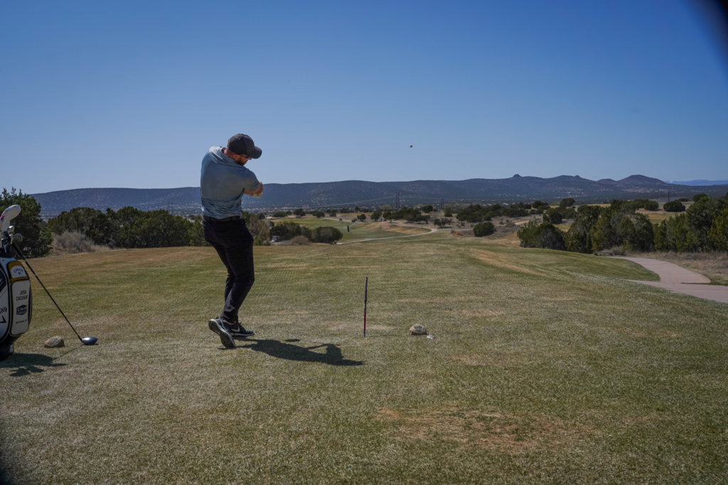 Golf Pro hitting off a tall tee