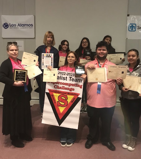 All Capital High School Supercomputing students and staff holding certificates and banner