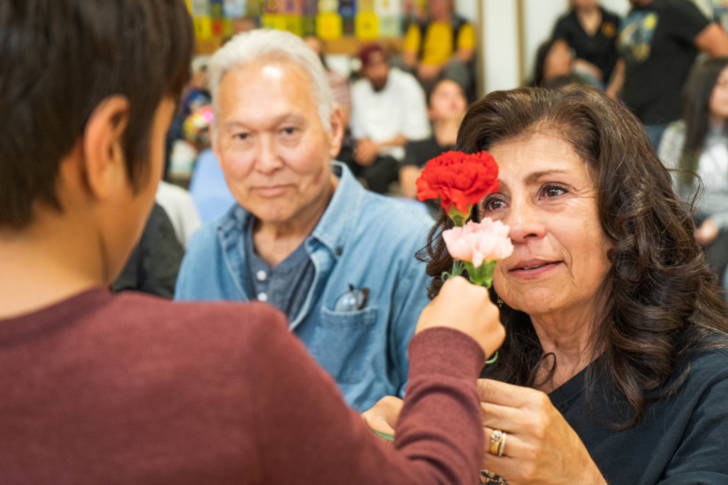 Ms. Ramona receives a flower from a student