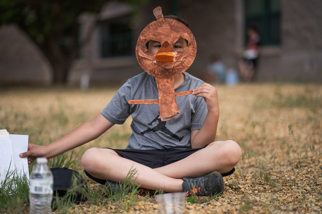 Student with an Ostrich mask over his face