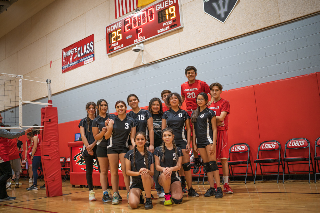 winning student volleyball team posing for a picture