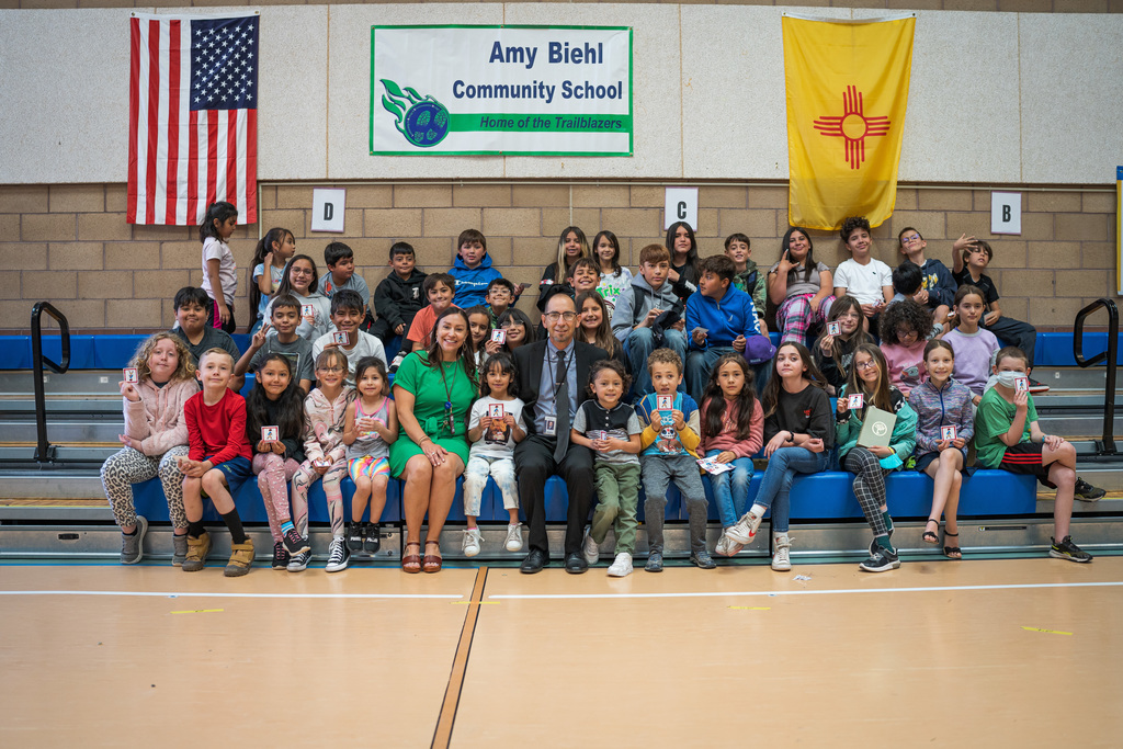 Amy Biehl students with principal Felicia Torres and Sueprintedent Chavez posing for a picture in the gym