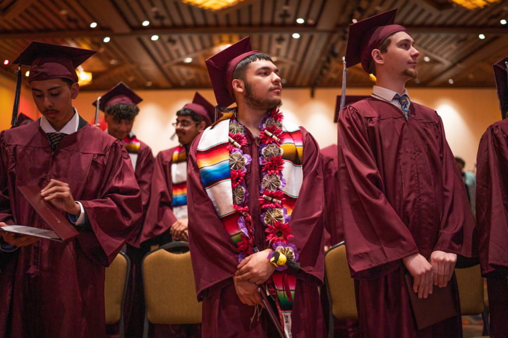 Students stand up for graduation