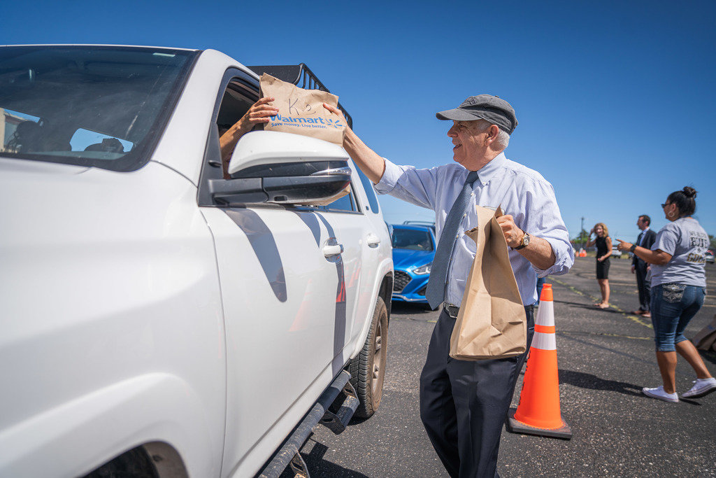 Mayor Webber handing school supplies to a parent in her vehicle